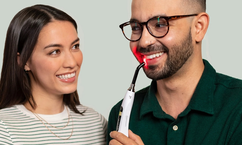 men and women holding luminance red device